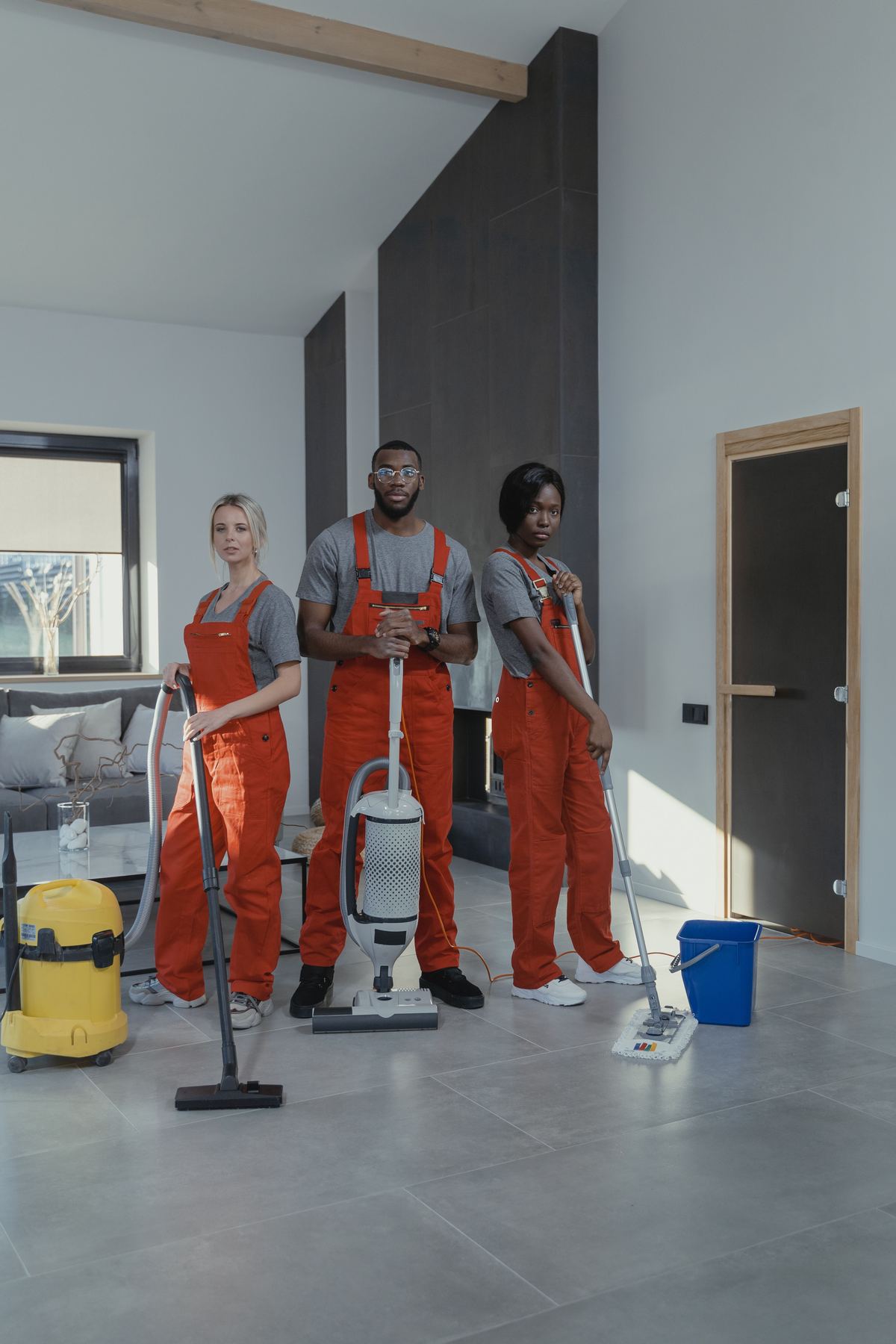 Three uniformed cleaning operatives with professional equipment